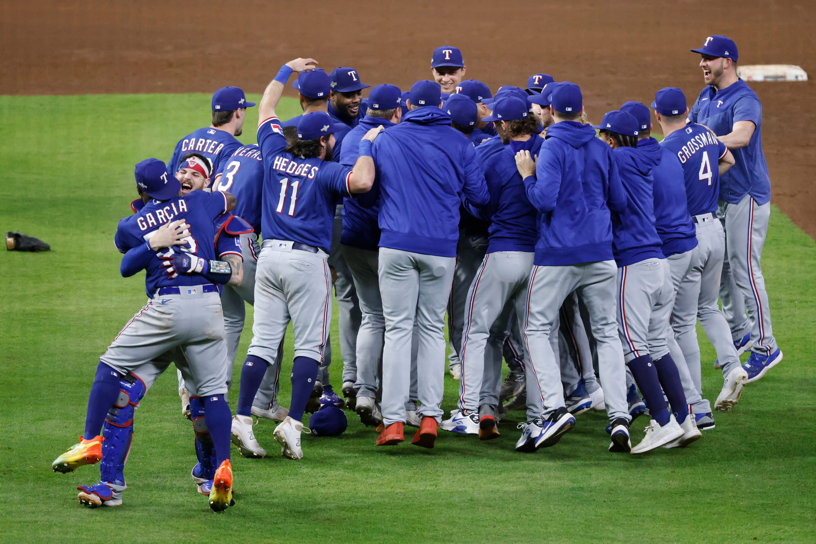 Texas Rangers right fielder Adolis Garcia (53) receives a congratulatory hug from catcher...