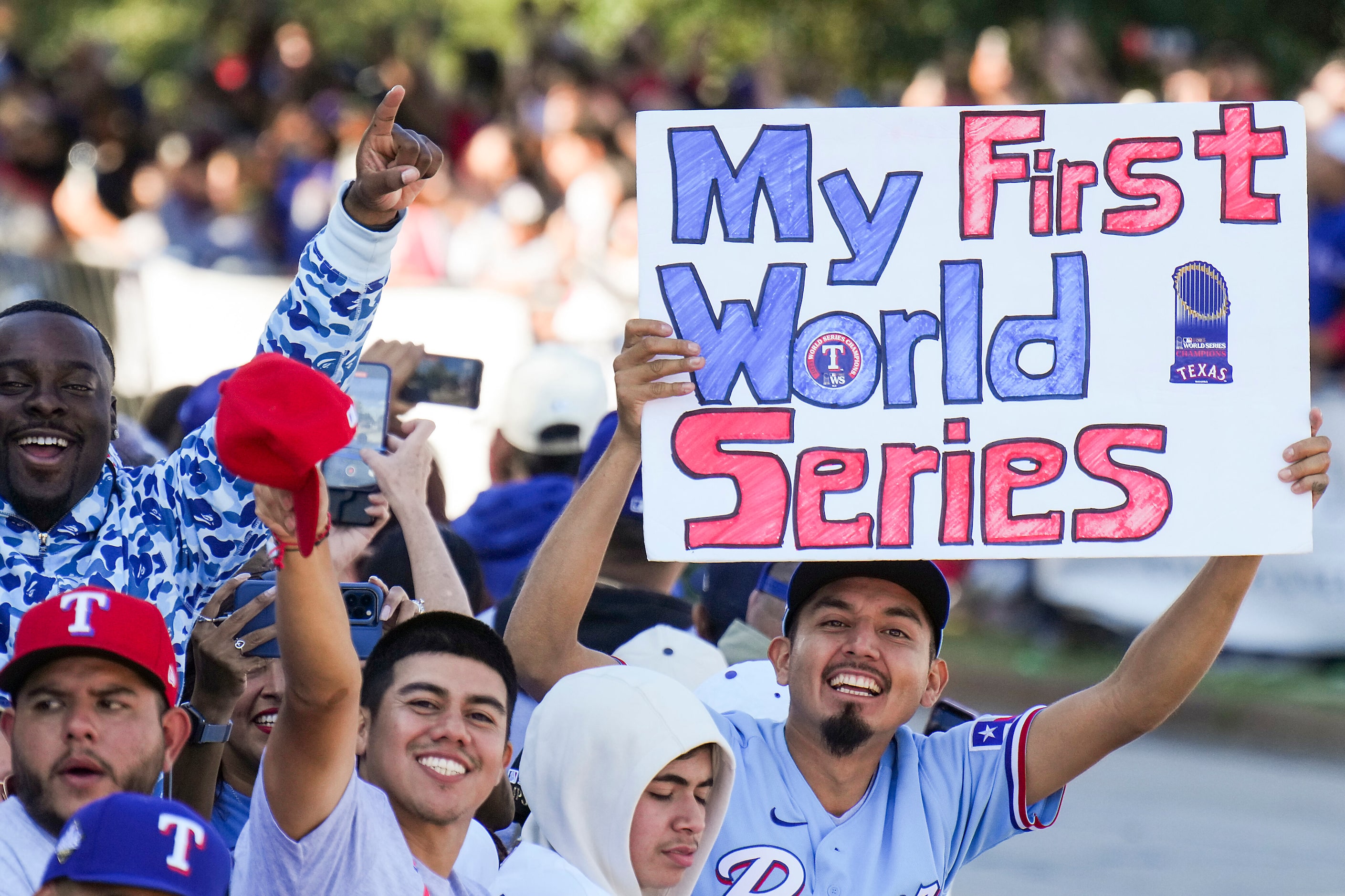 Fans cheer along the parade route during the Texas Rangers World Series victory parade,...