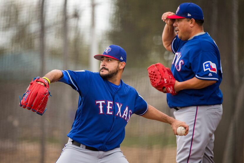 Texas Rangers pitchers Martin Perez (left) and Bartolo Colon work in the bullpen during a...