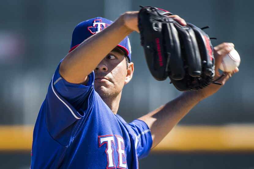 Texas Rangers pitcher Cesar Ramos throws live batting practice during a spring training...