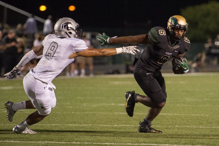 DeSoto junior running back Kelan Walker (6) slips away from Denton Guyer senior linebacker...