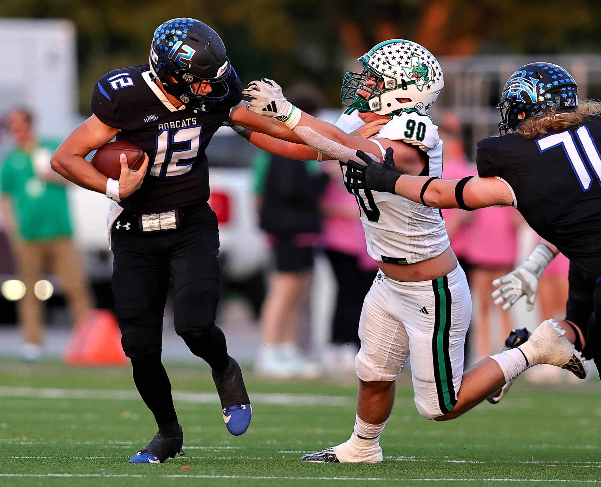 Byron Nelson quarterback Tom Von Grote (12) tries to elude Southlake Carroll defensive...
