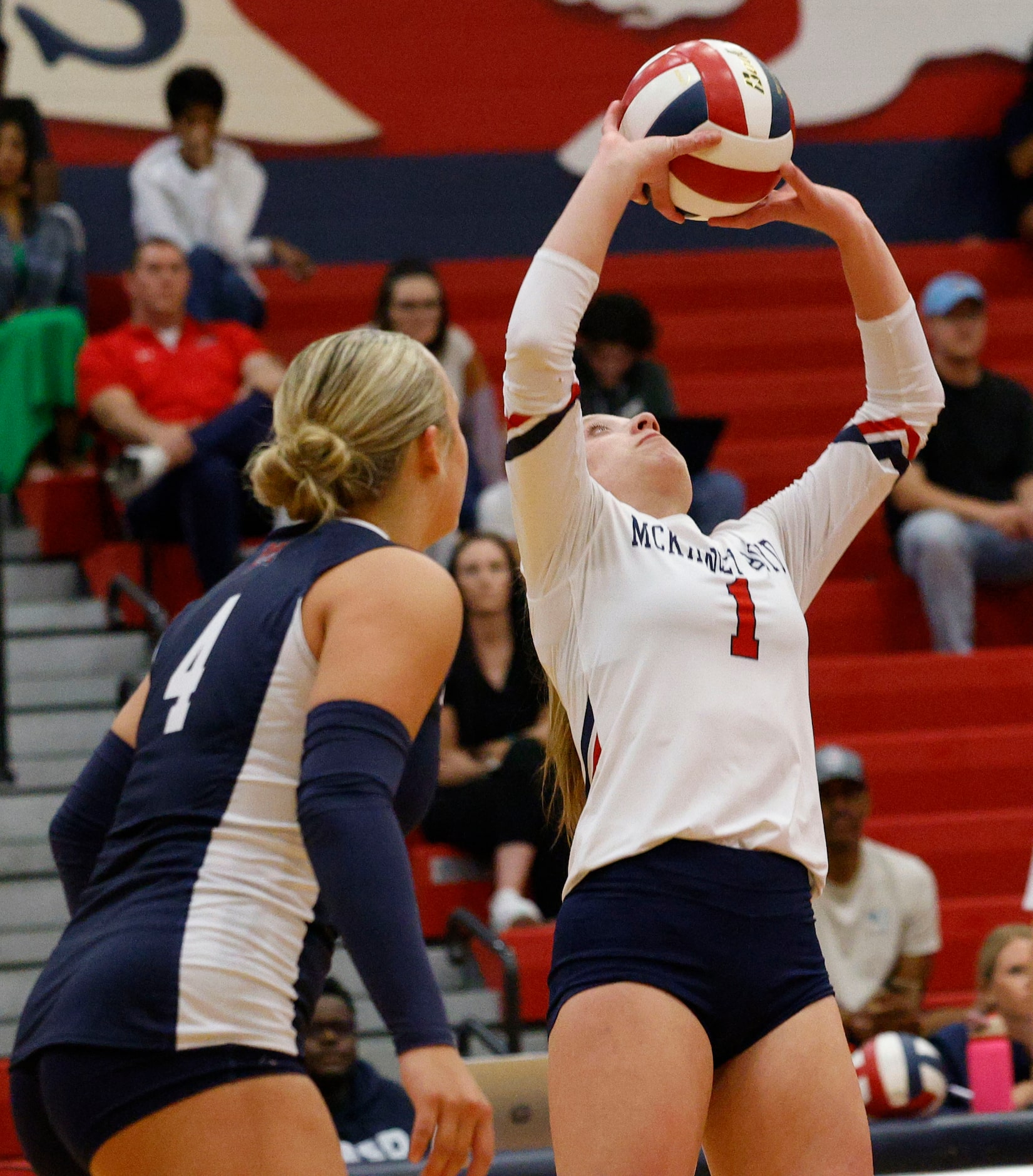 McKinney Boyd's Ale Romo (1) sets the ball as Plano East's Shelbi Kozlowski (4) looks on in...