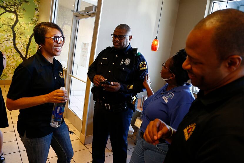 Dallas police Chief Renee Hall (left) laughs with Officer Mitchell Gatson; Michelle Lowe,...