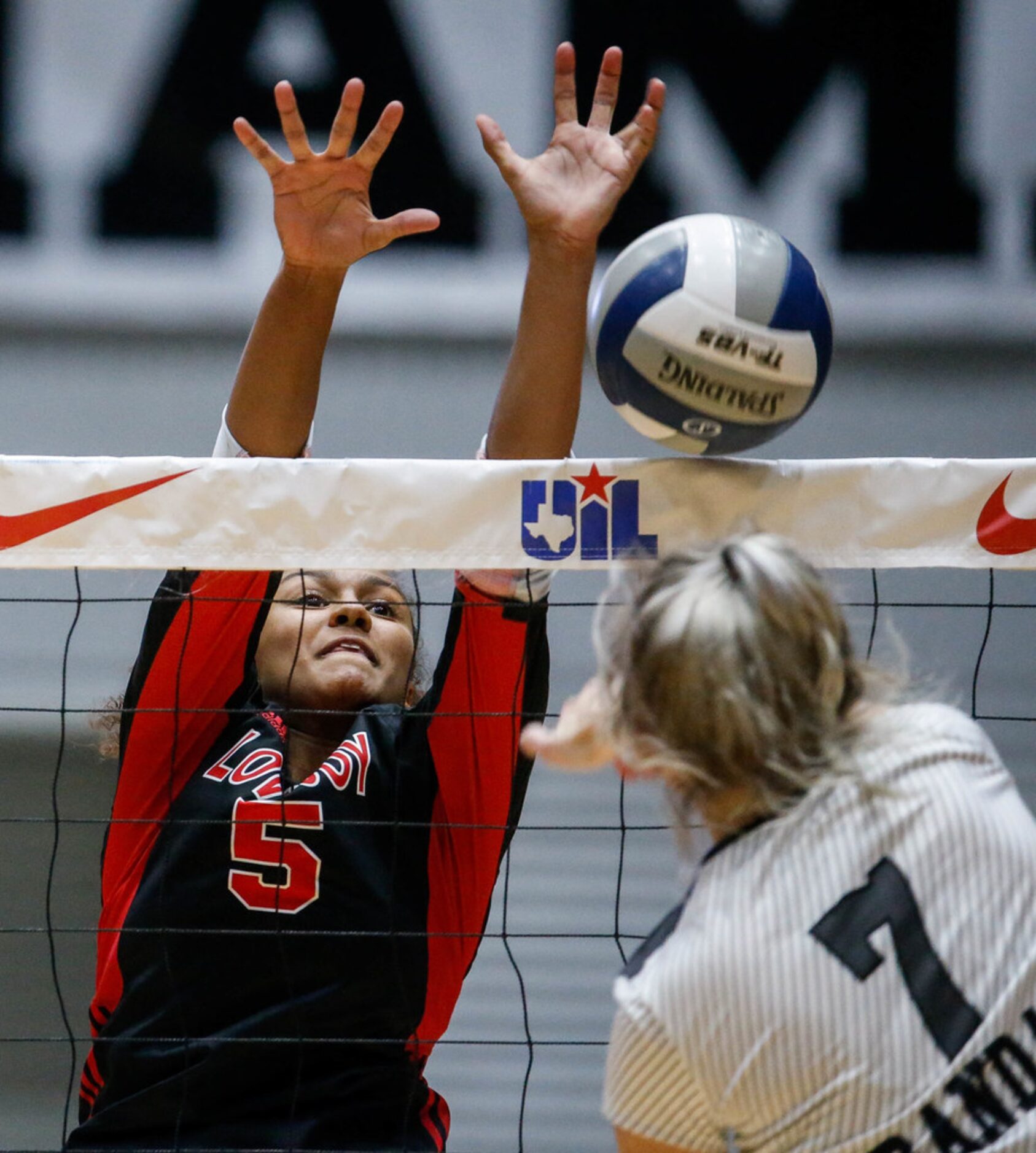 LovejoyÃs Cecily Bramschreiber  (5) attempts to block Canyon RandallÃs Kiar Parker (7) hit...