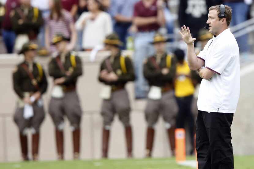 Texas A&M Aggies offensive coordinator Jake Spavital communicates to his players during the...