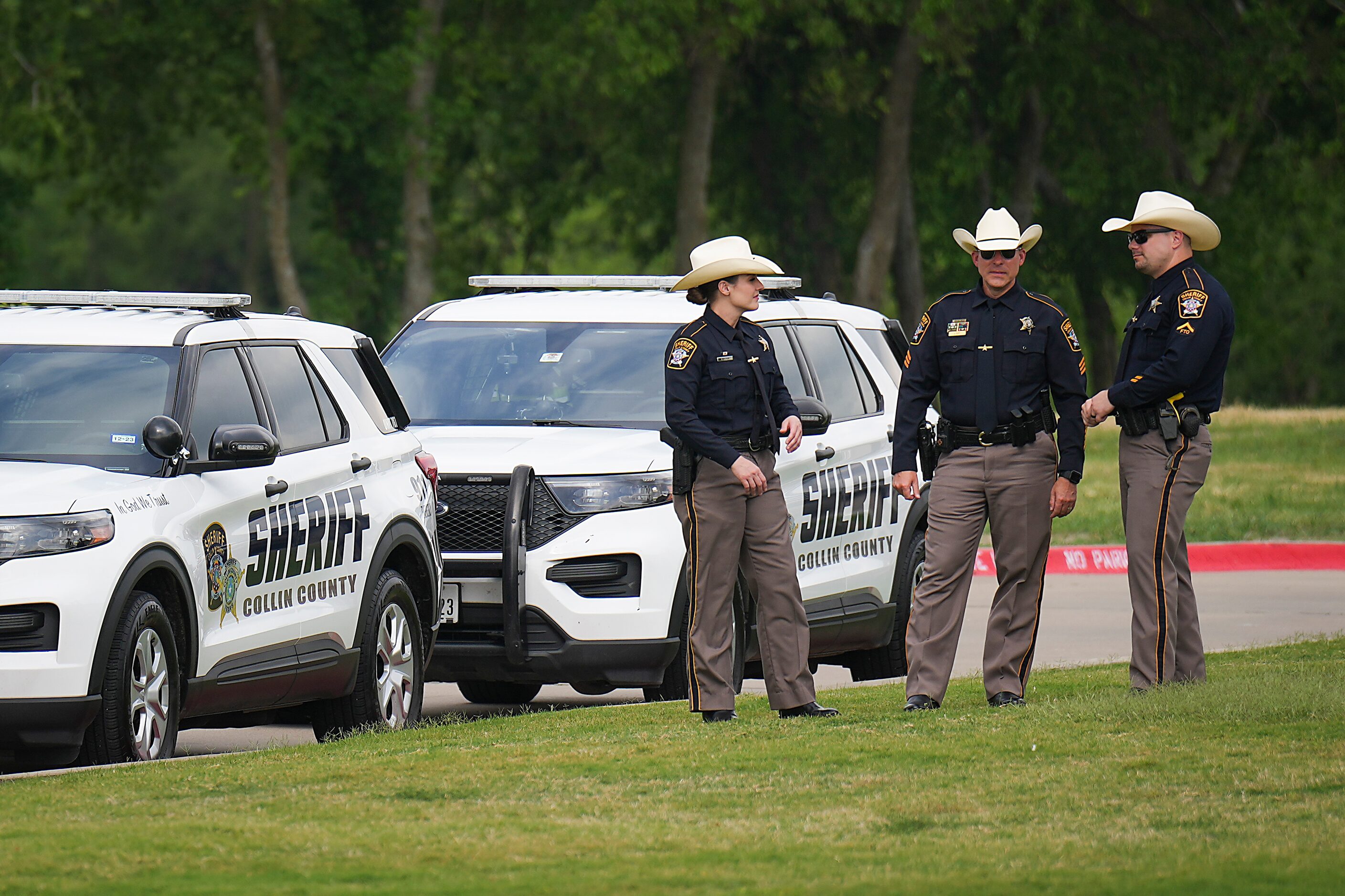 Collin County Sheriffs stage outside before a vigil at Cottonwood Creek Church a day after a...