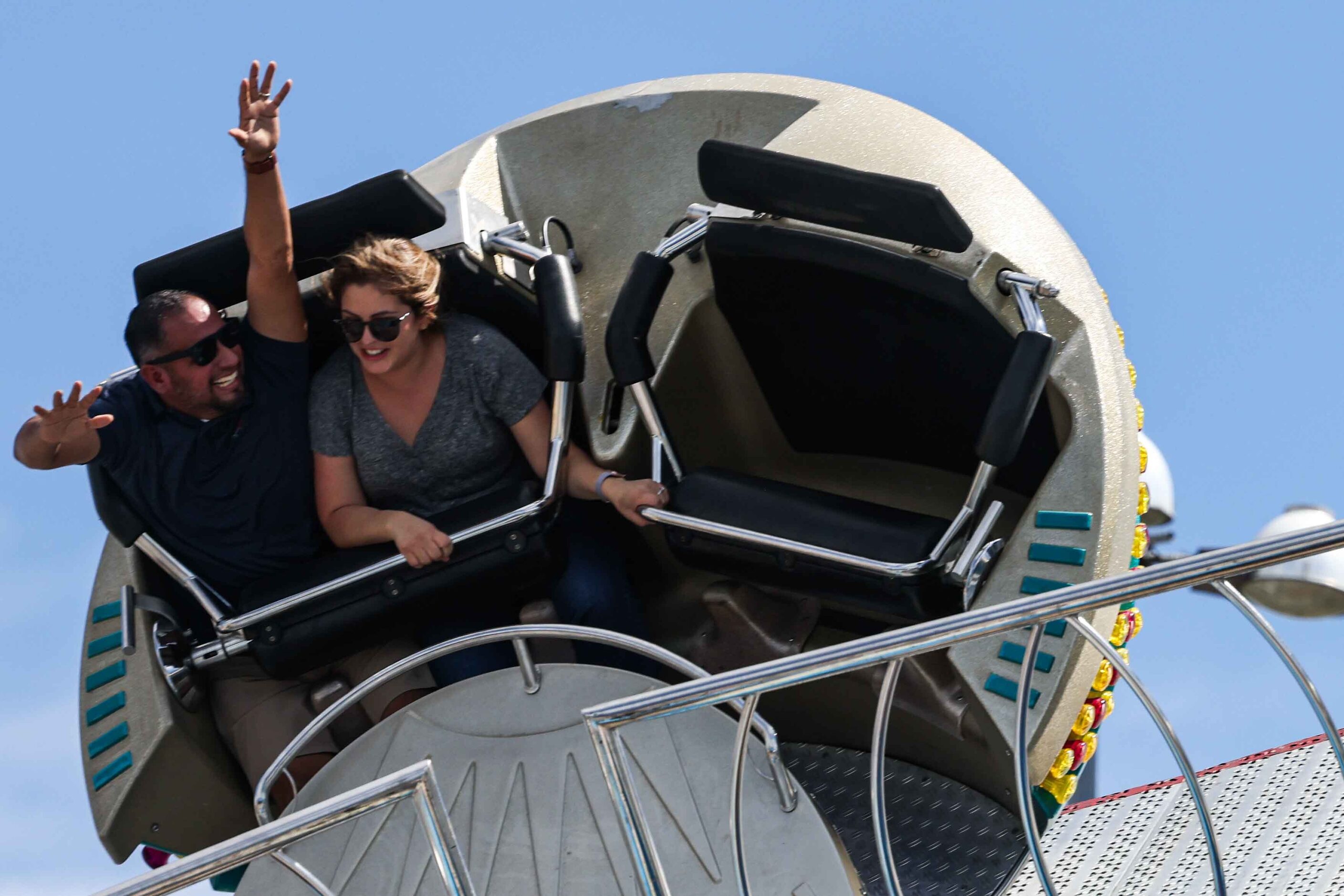 People aboard a carnival ride at the State Fair of Texas during its opening day in Dallas on...