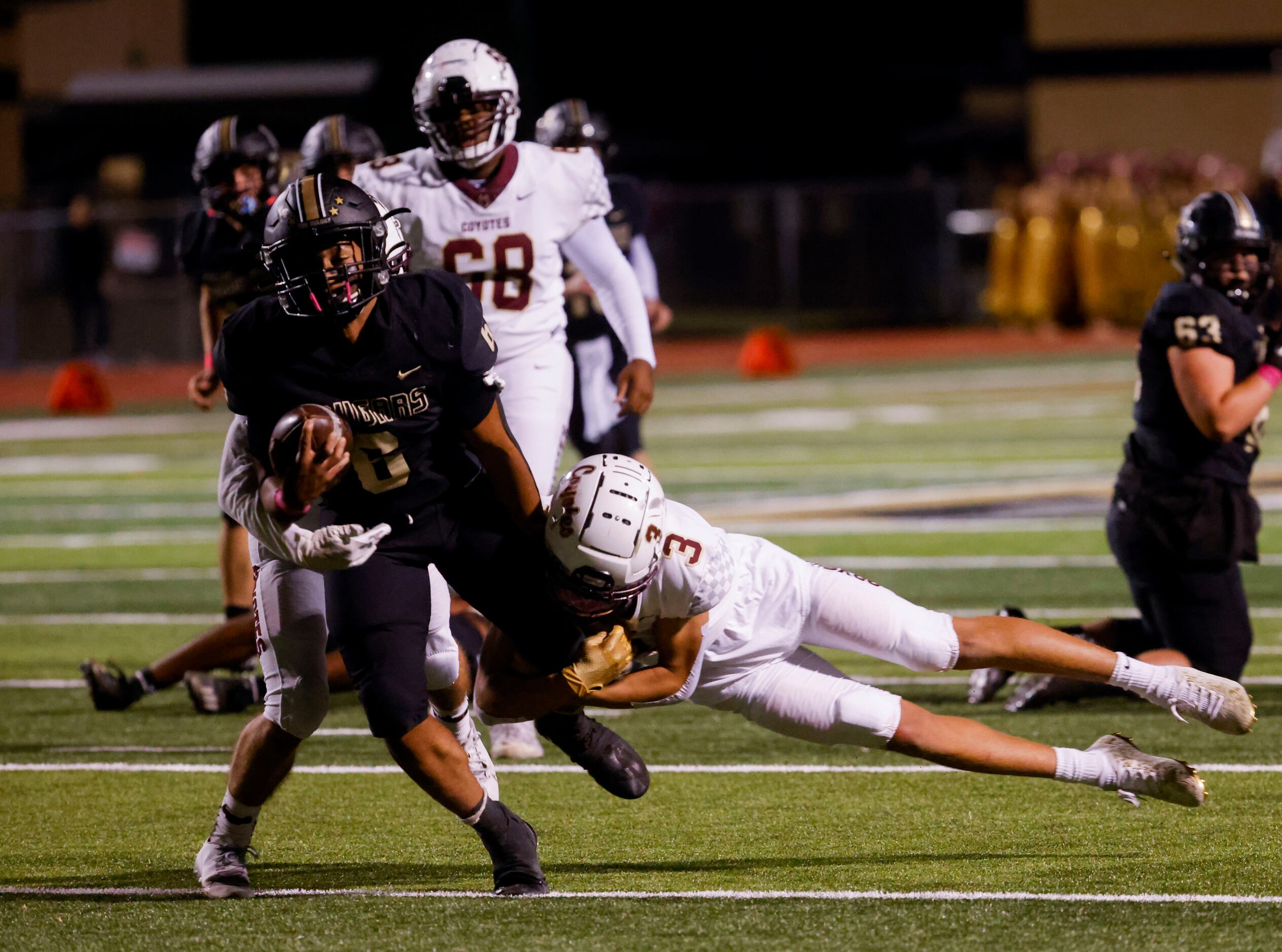 The Colony’s running back Kamden Wesley (6) is stopped by Frisco Heritage’s DB Quinton Clay...
