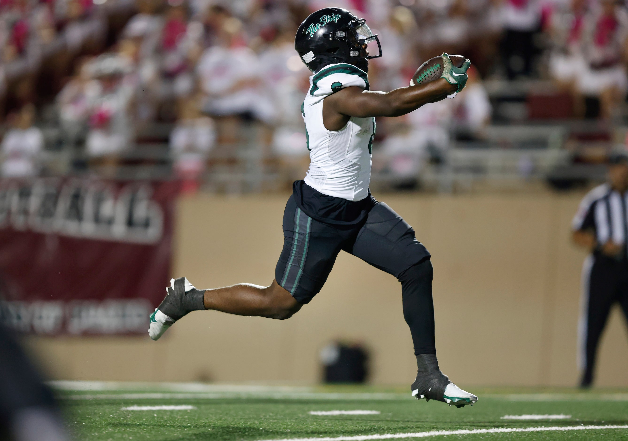 Prosper High running back Bryce Robinson (6) reaches for the goal line for a first half...