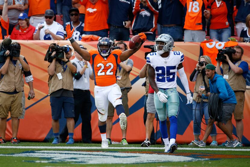 Denver Broncos running back C.J. Anderson (22) celebrates after making a touchdown against...