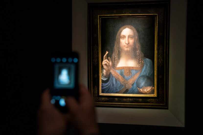 A visitor took a photo of the painting Salvator Mundi by Leonardo da Vinci at Christie's New...