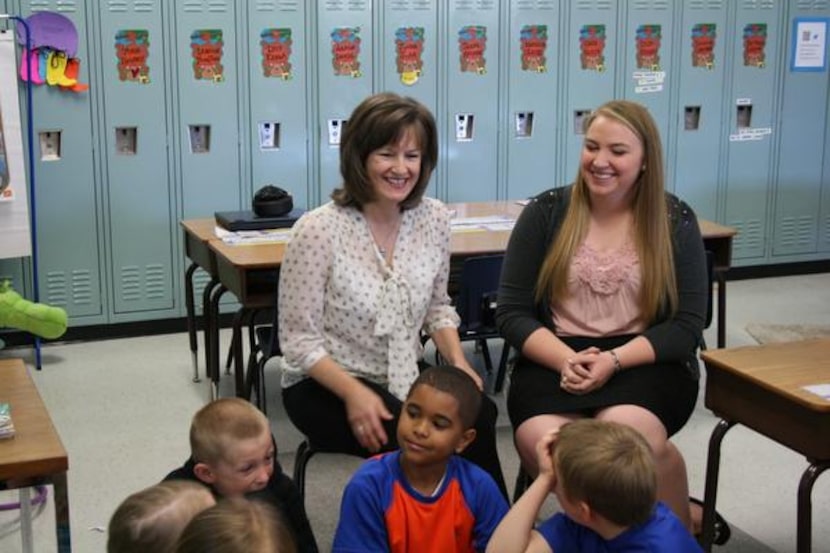 
Pam Taylor (left) and Shannon Musslewhite listen to student reading presentations at Garden...