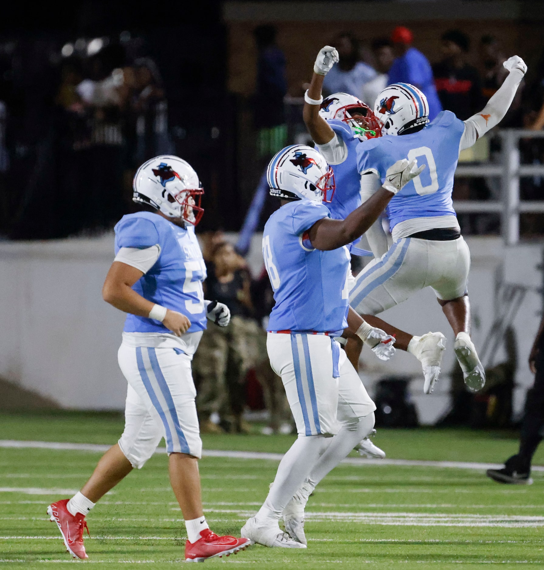 Skyline high players celebrate after winning a football game against North Forney, on...