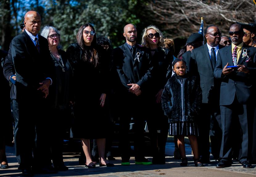Family members wait as the remains of Richard Overton are transported to his grave site...
