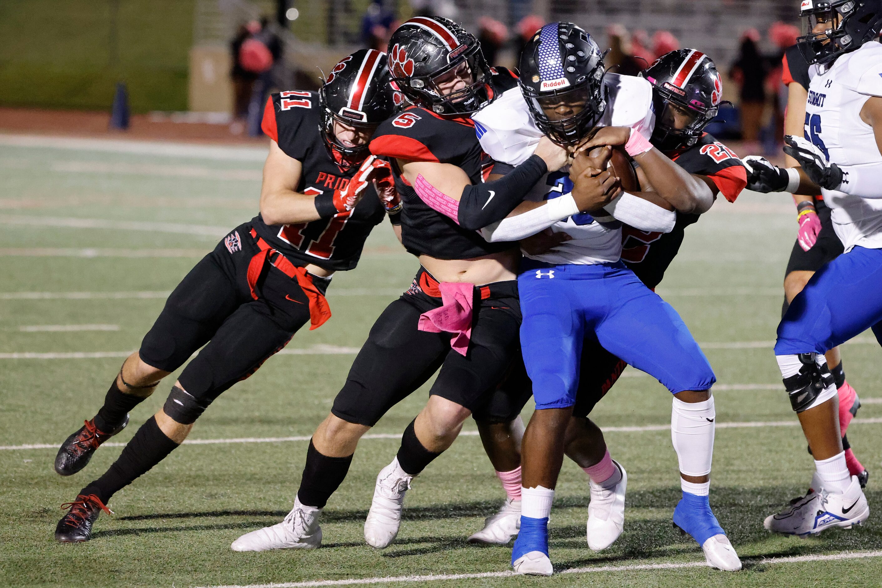 Mansfield Summit running back Orlando Scales (23) is tackled by Colleyville Heritage...