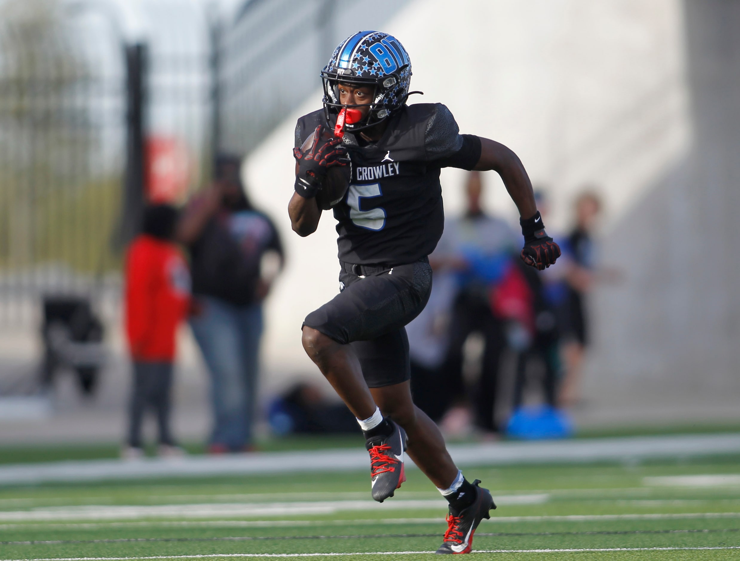 North Crowley receiver Quintin Gibson (6) tacks on yardage after a catch during second half...