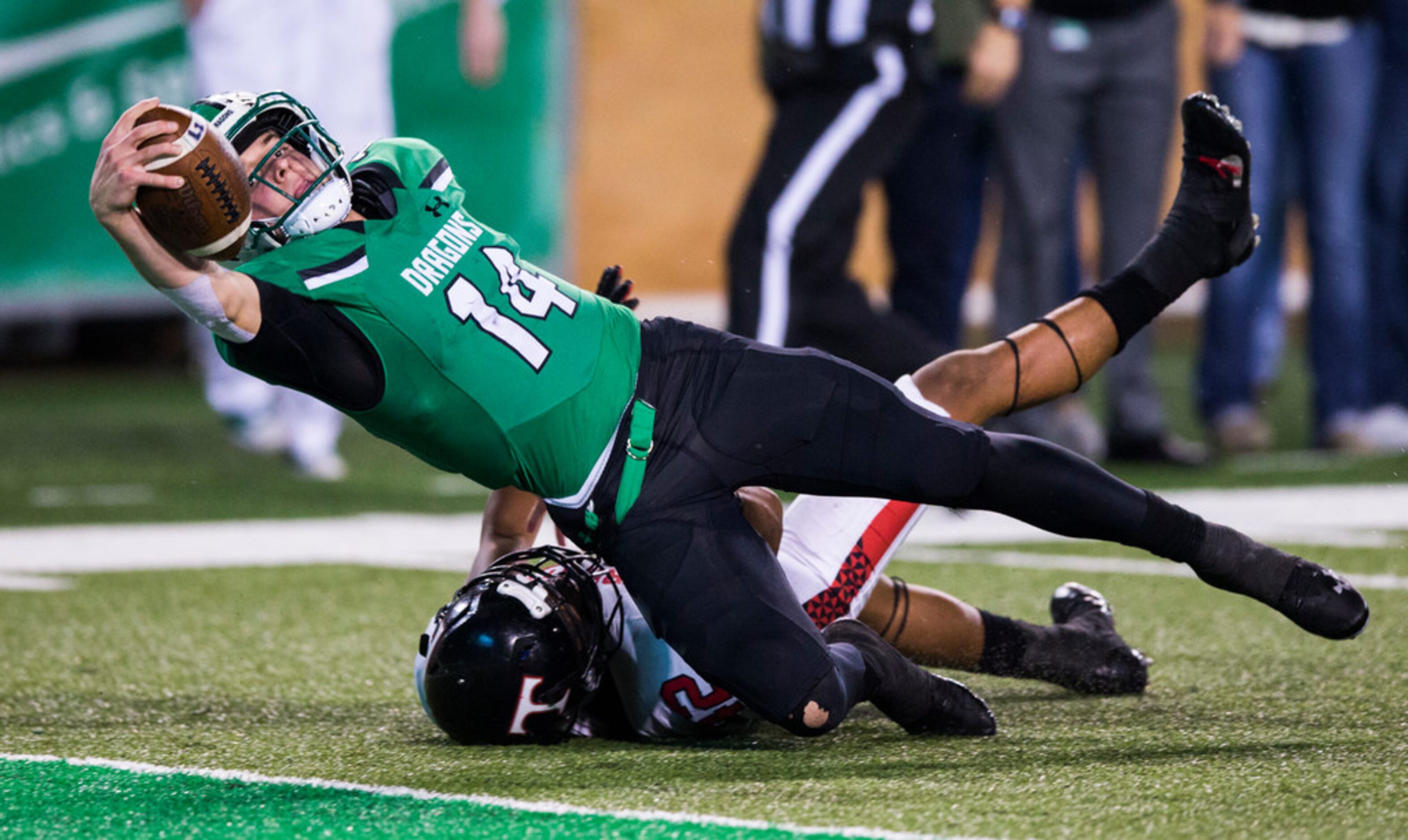 Southlake Carroll quarterback Will Bowers (14) reaches across the goal line for a touchdown...