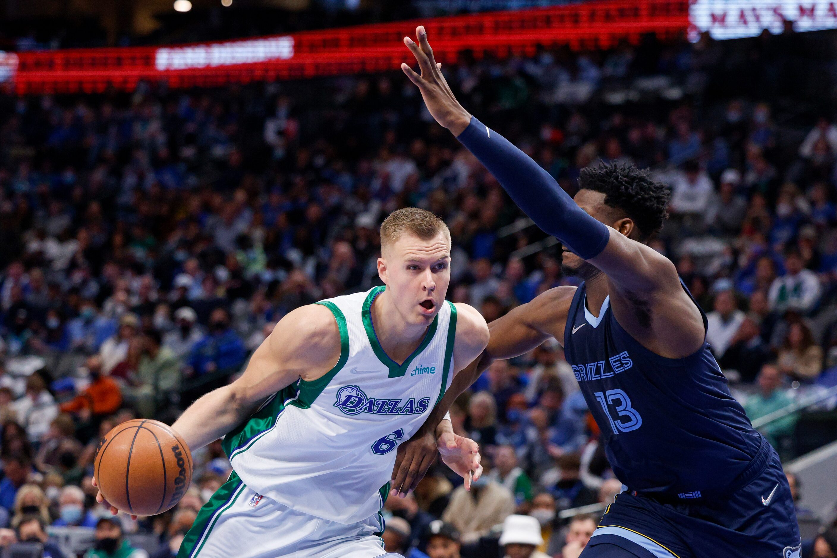 Dallas Mavericks center Kristaps Porzingis (6) drives past Memphis Grizzlies forward Jaren...