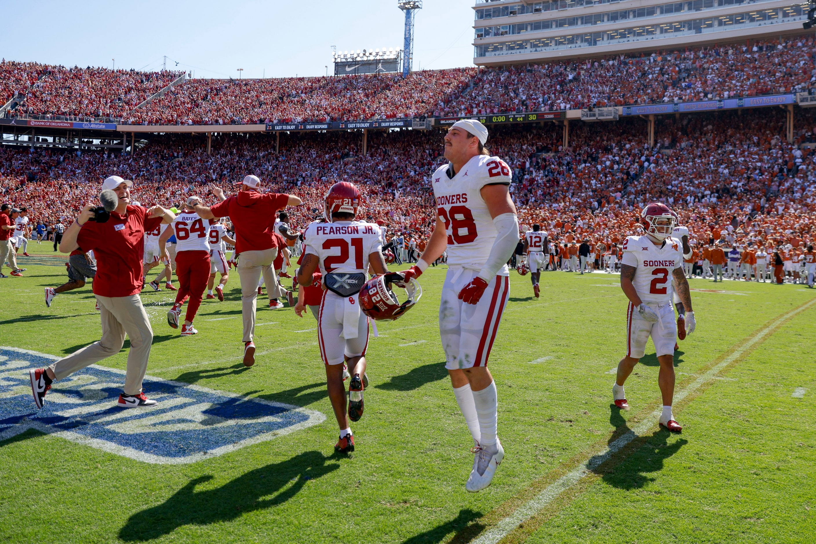 Oklahoma players cheer after defeating Texas during the Red River Rivalry at the Cotton...