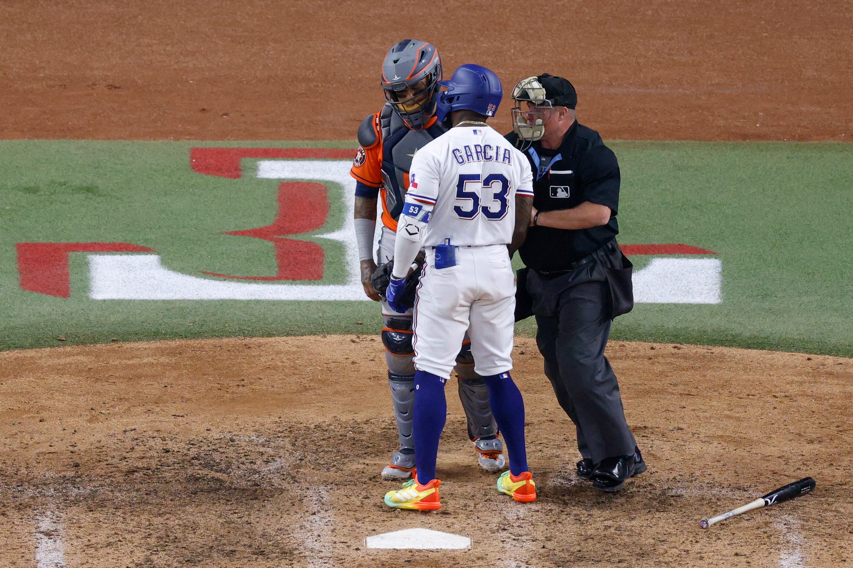 Texas Rangers right fielder Adolis Garcia (53) confronts Houston Astros catcher Martin...