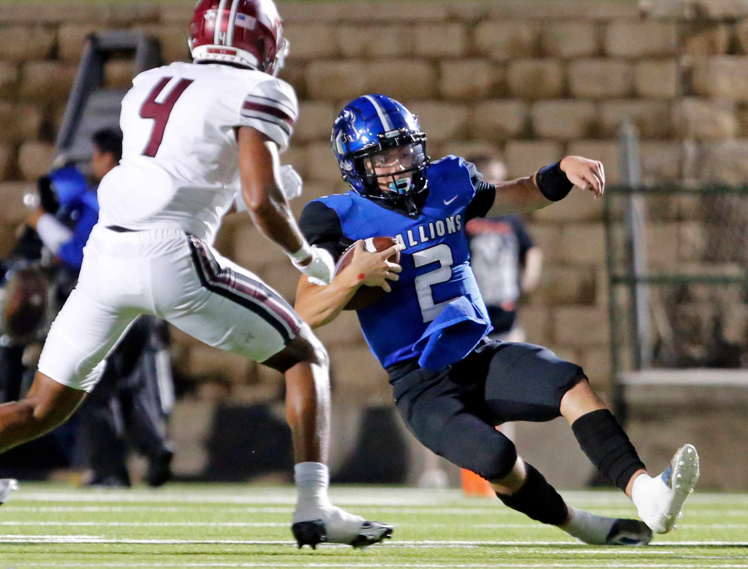 North Mesquite QB Luke Seder (2) scrambles and slides for a first down, as Mesquite defender...