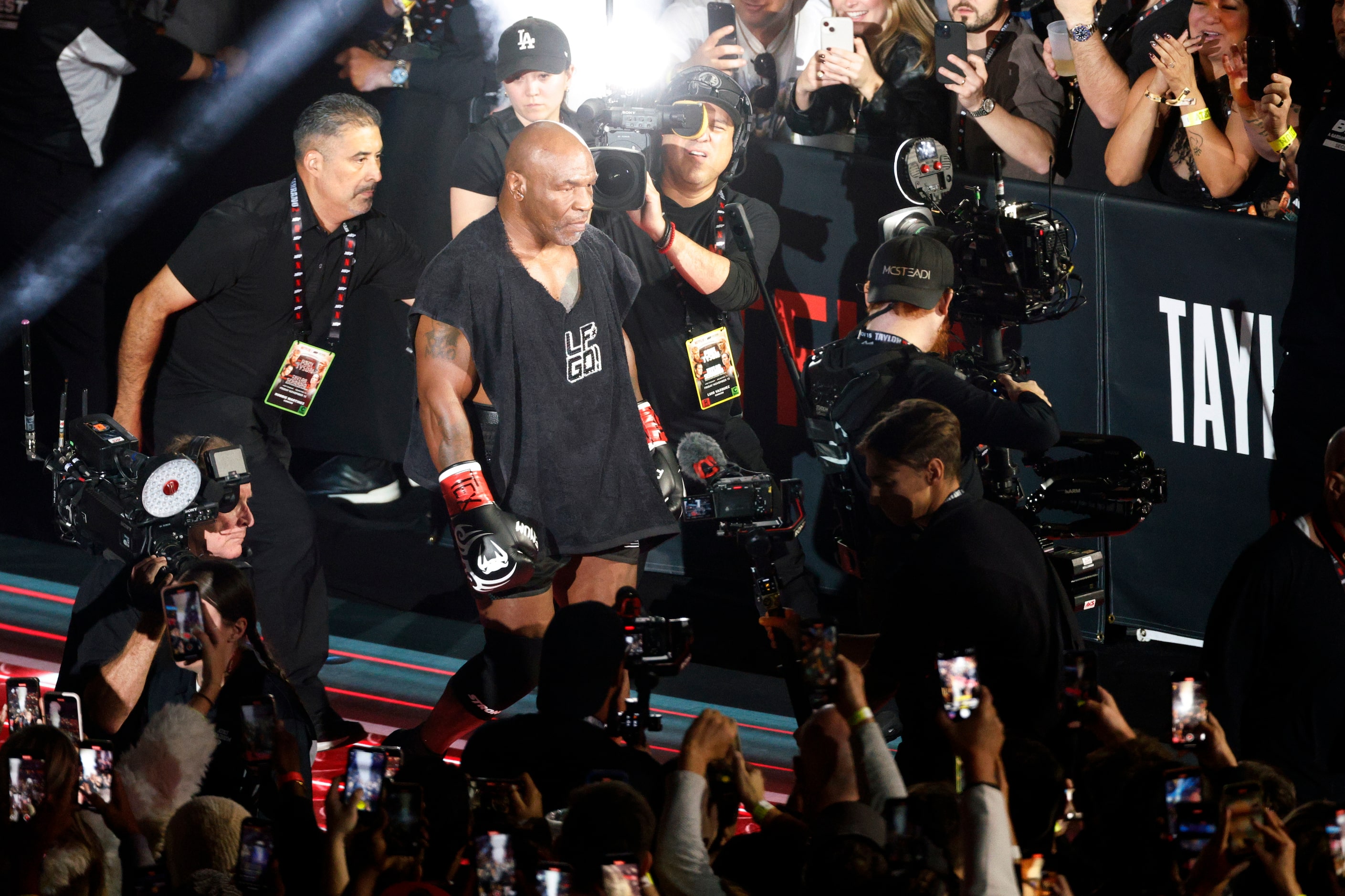 Mike Tyson makes his way to the ring before a heavyweight boxing match against Jake Paul,...