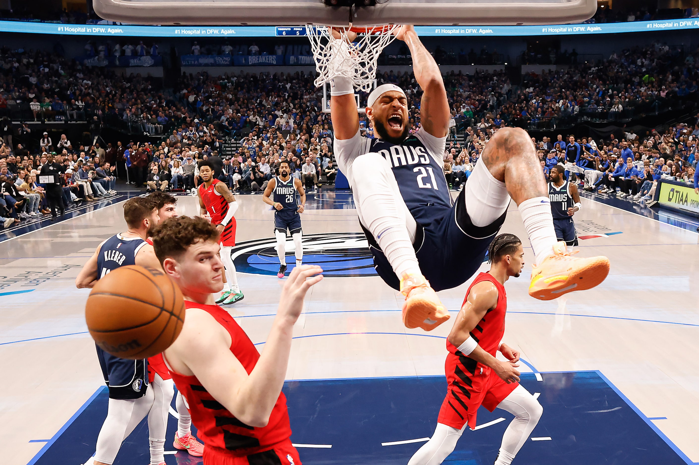 Dallas Mavericks center Daniel Gafford (21) dunks the ball past Portland Trail Blazers...