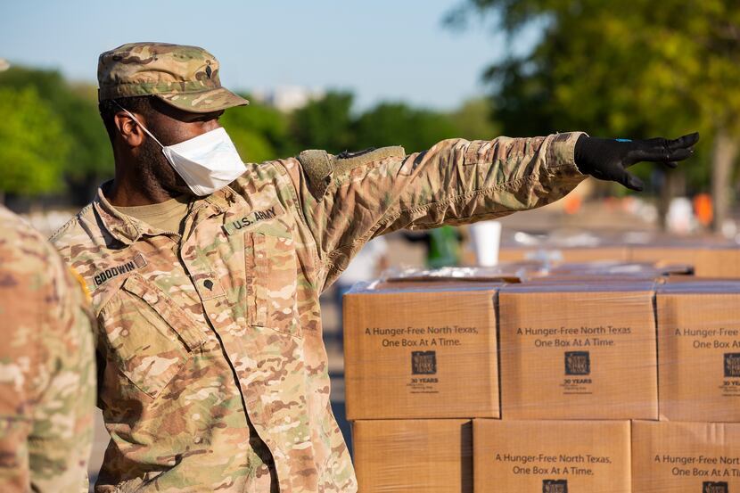 The Texas National Guard helps the North Texas Food Bank distribute free food at Fair Park...