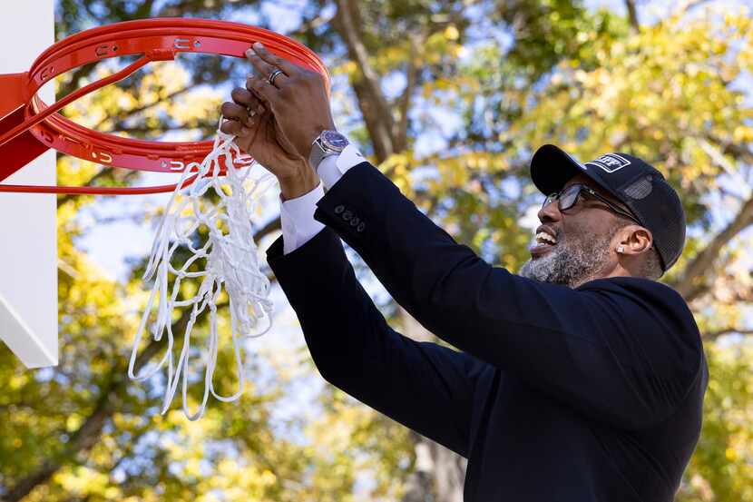 South Oak Cliff ambassador and community advocate Derrick Battie helped hang the basketball...