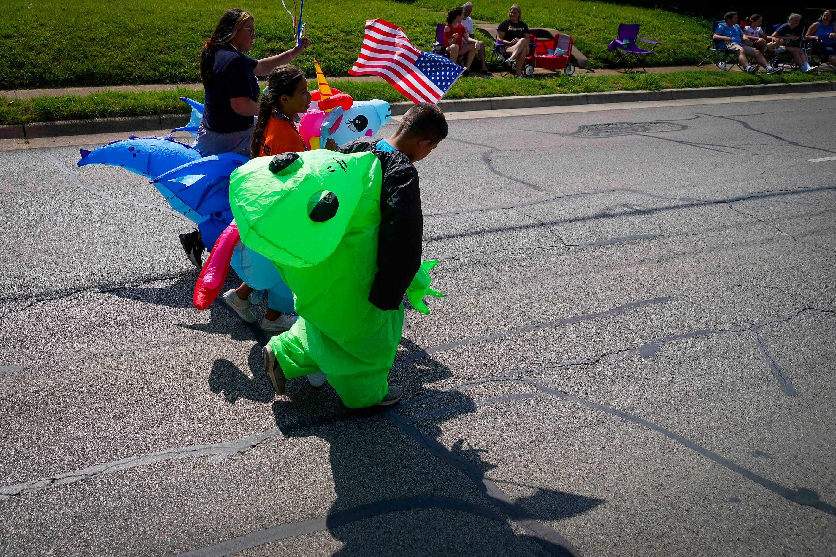 Participants head down Center Street during the Arlington Independence Day Parade on Monday,...