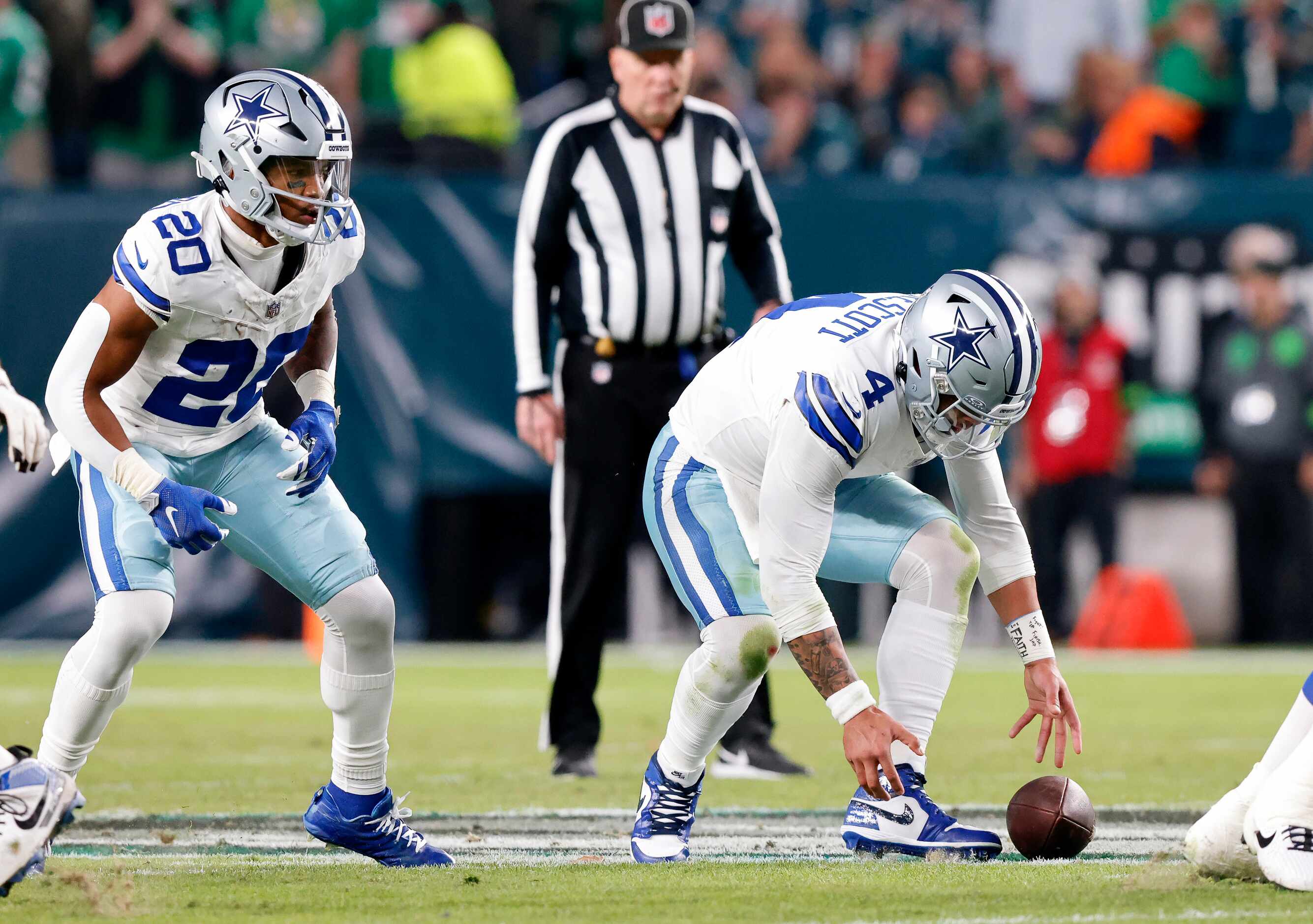 Dallas Cowboys quarterback Dak Prescott (4) drops the snap in the first half before handing...