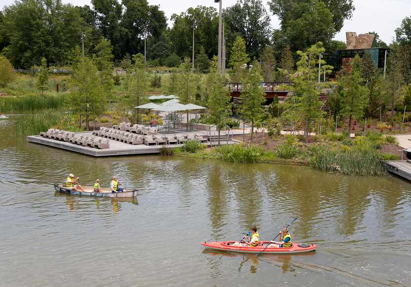 Boaters paddled on Peggy Pond at Gathering Place in Tulsa in July 2019. New Dallas Park...