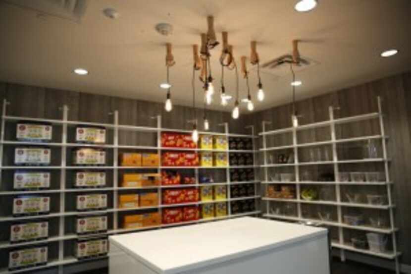  A pantry filled with snacks has whimsical lighting at rewardStyle's new office in The...