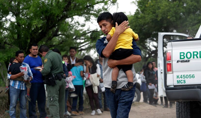 Jose Fermin Gonzalez Cruz holds his son, William Josue Gonzales Garcia, 2, on March 14 as...