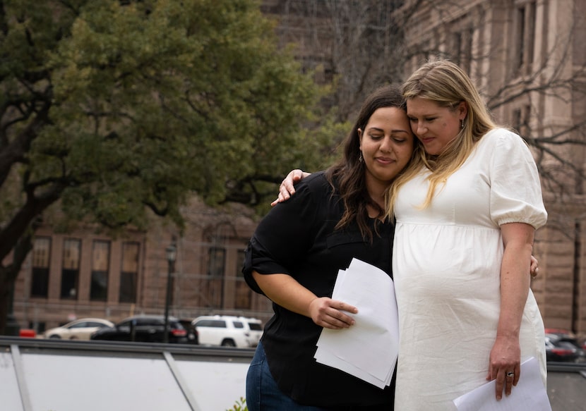 Lauren Miller, right, embraces Anna Zargarian after speaking as part of an announcement that...