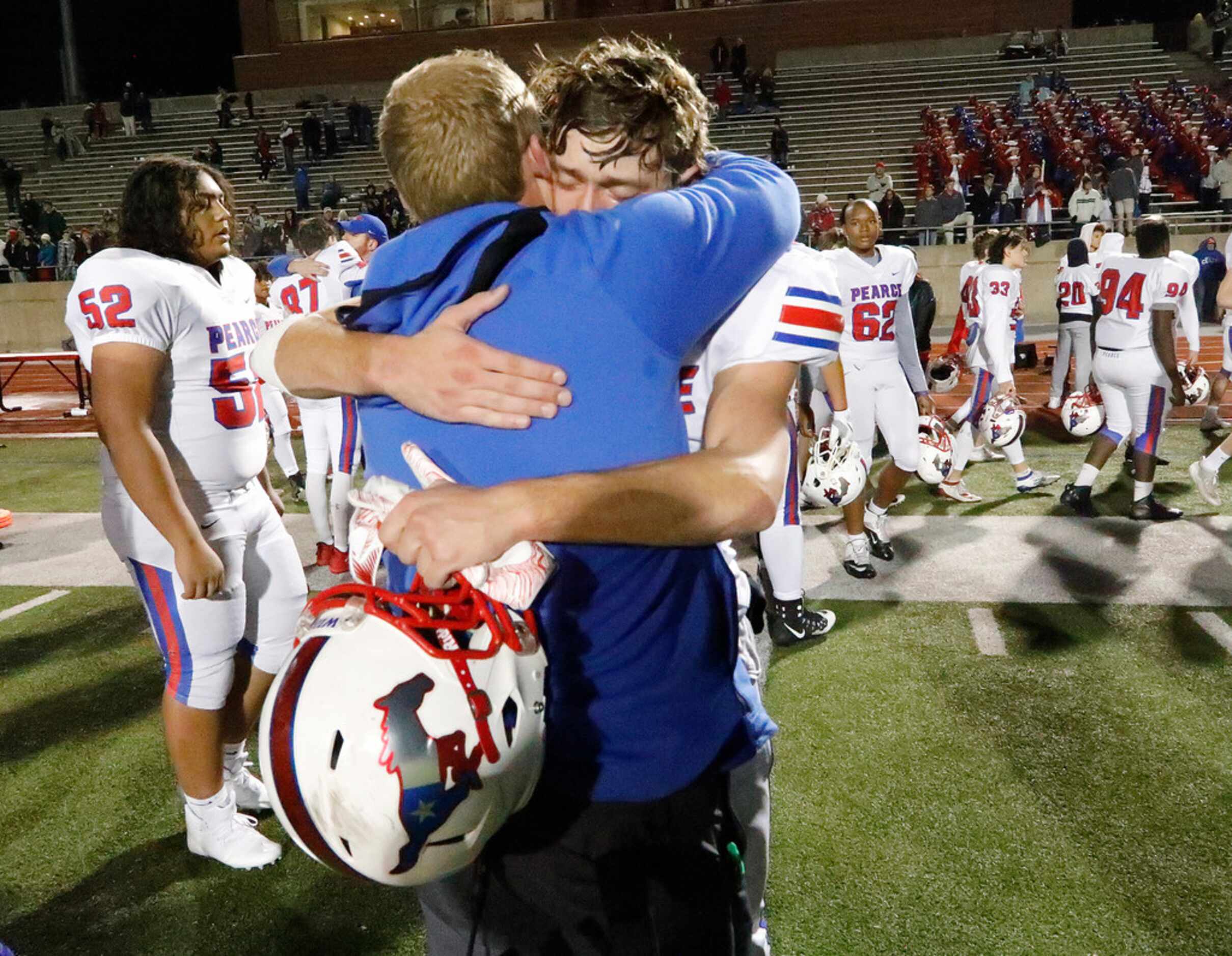 Pearce High School head coach David Collins consoles Pearce High School wide receiver Zack...