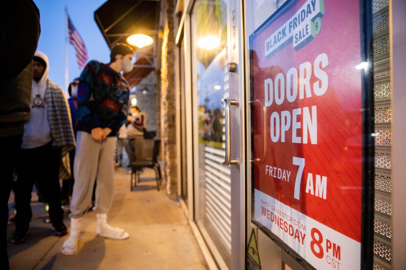 Fabian Reyher peers through the window Friday morning after waiting in line since 2 p.m....