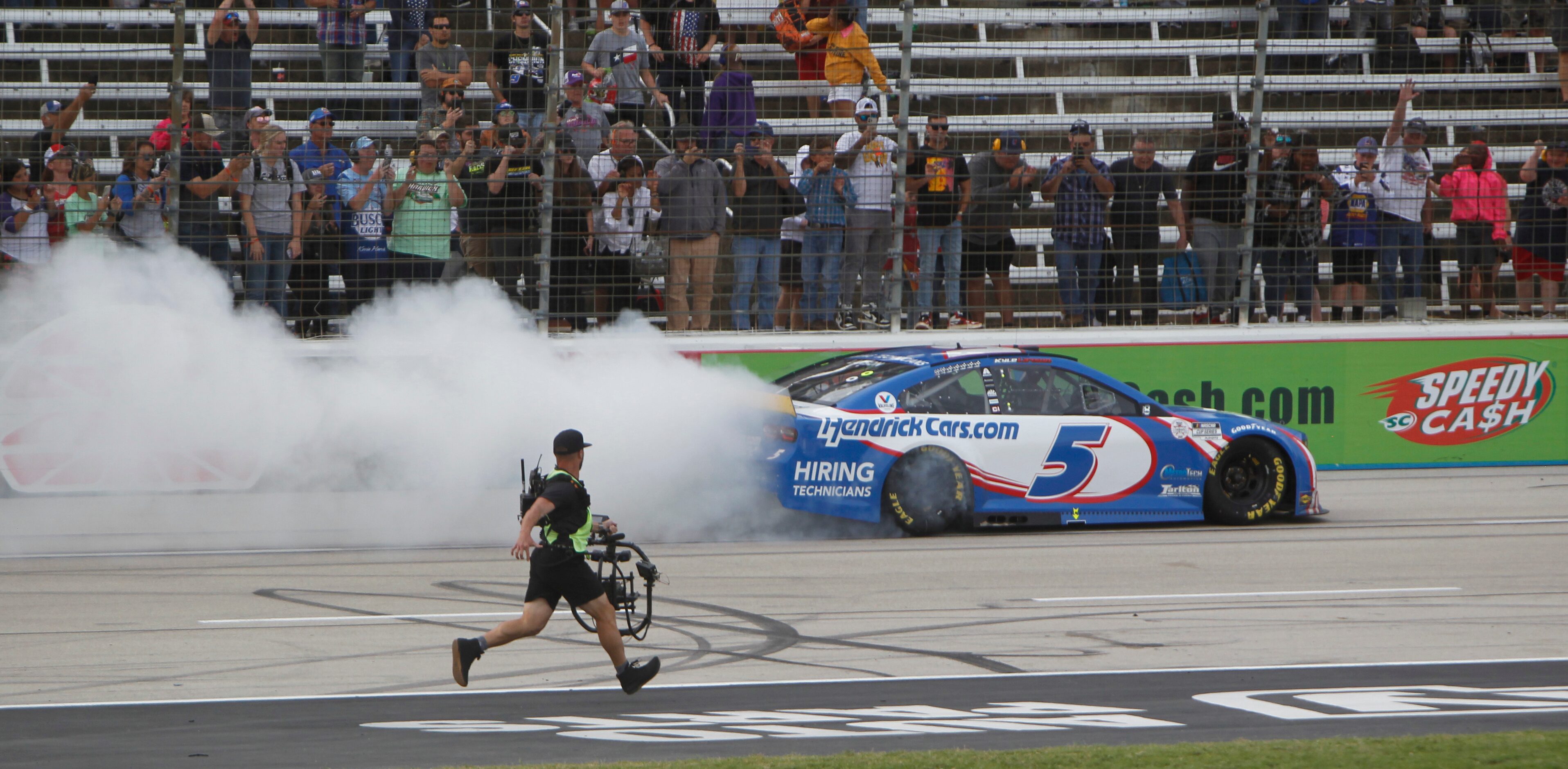 Kyle Larson spins his tires after his victory from behind the wheel of the number 5...