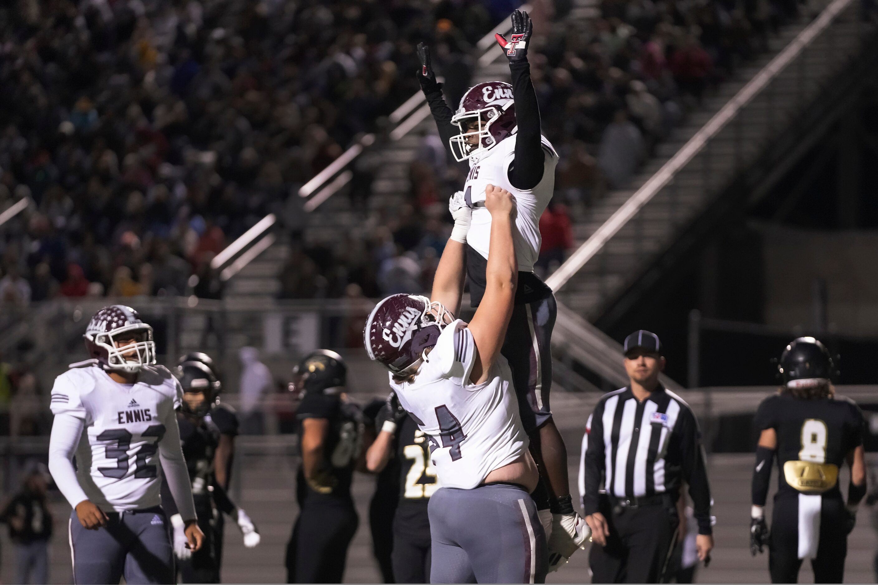 Ennis running back Devion Beasley (1) celebrates with offensive lineman Cody Jurcik (64) on...