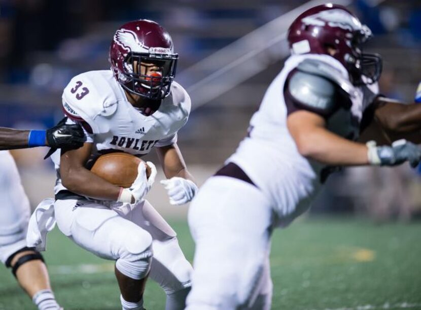 
Rowlett running back Kobe Morrow (33) follows his blocking in gaining 69 yards rushing...