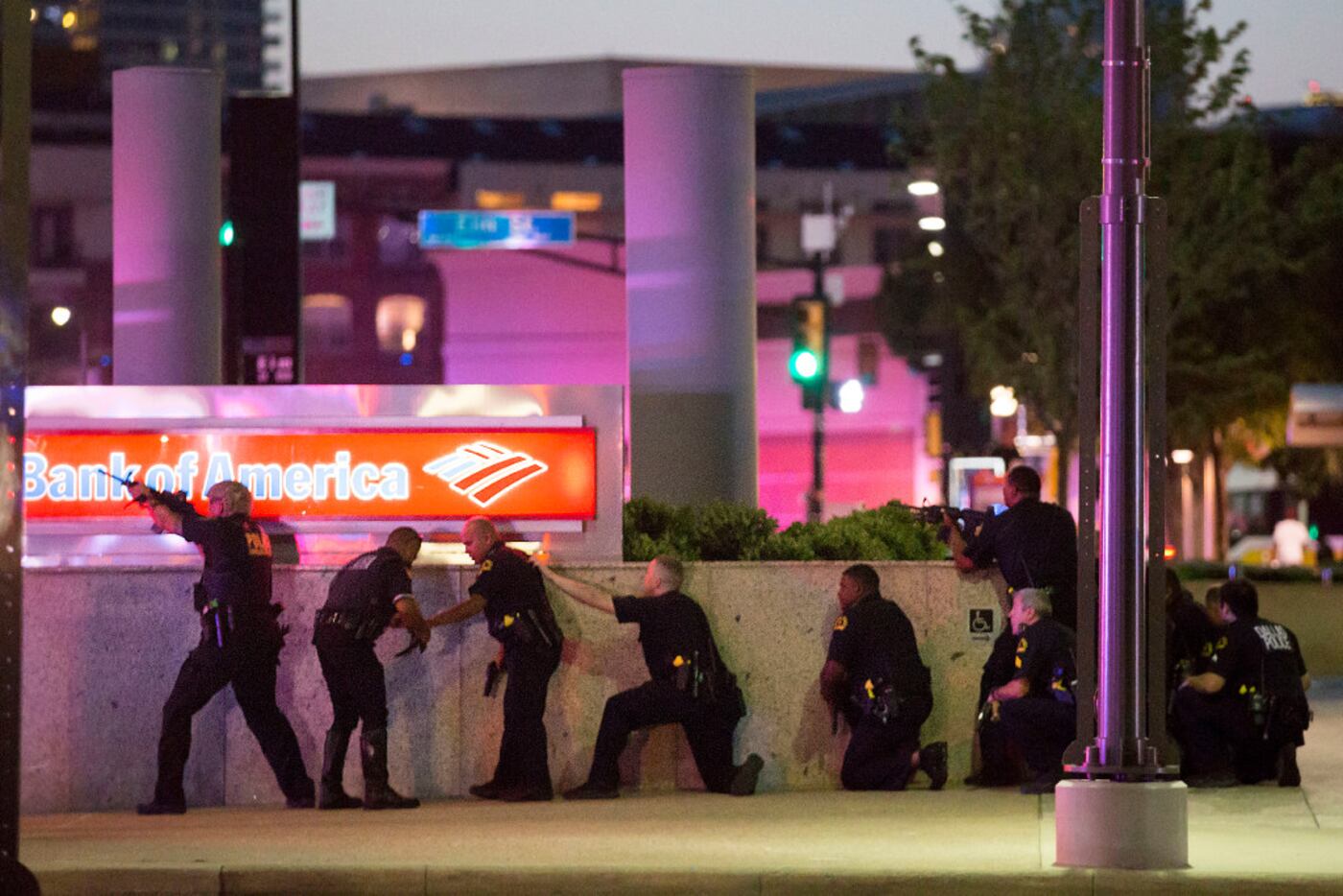 Dallas officers took up positions along a wall at the corner of Lamar at Main streets during...