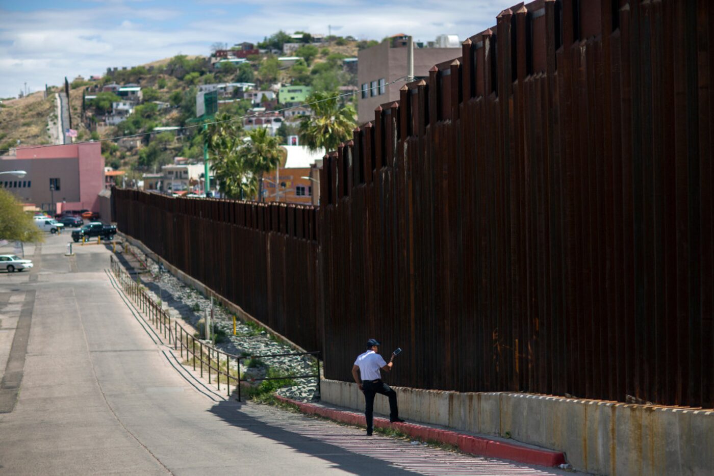 In this April 1, 2017, photo, a man in Nogales, Ariz., talks to his daughter and her mother...