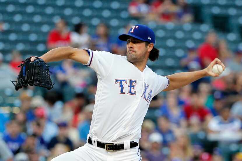 Texas Rangers' Cole Hamels throws to the Seattle Mariners in the second inning of a baseball...