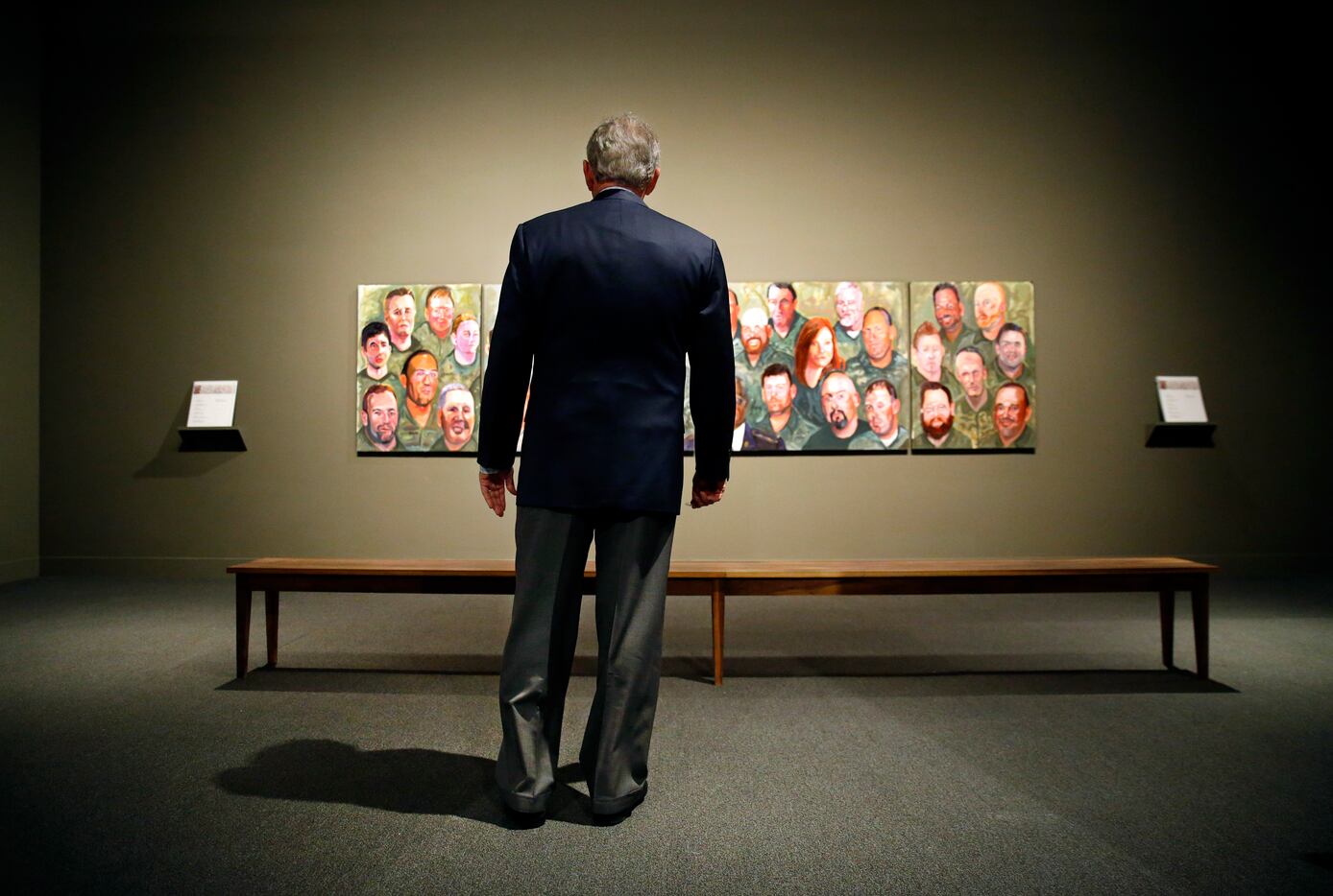 Former President George W. Bush takes his first look at the "Portraits of Courage: A...