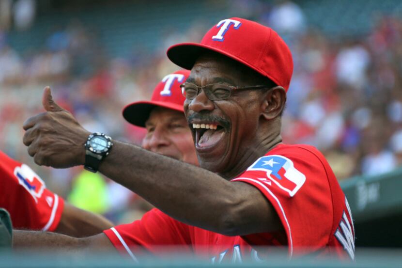 Texas manager Ron Washington shares a laugh with bench coach Jackie Moore before the Houston...