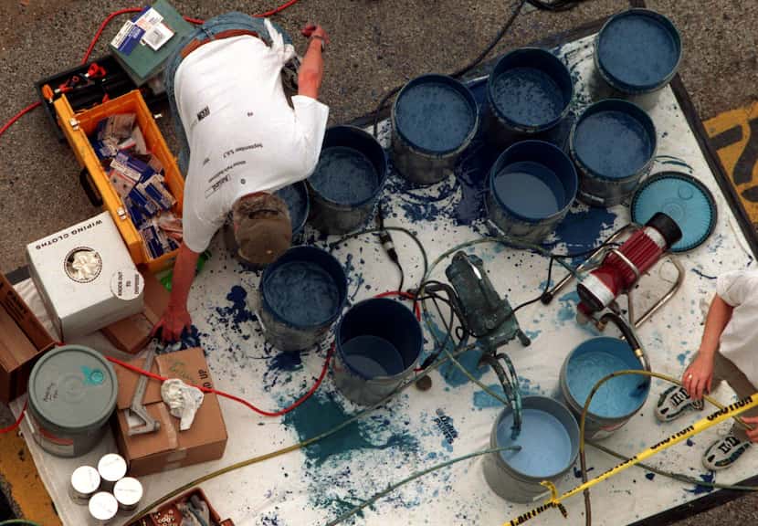 In this 1999 file photo, volunteers keep the paint pumping for Wyland the artist as he works...