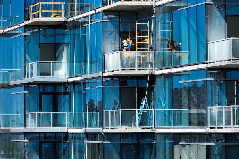 Construction is seen on a new building next to Saint Michael and All Angels Episcopal Church...