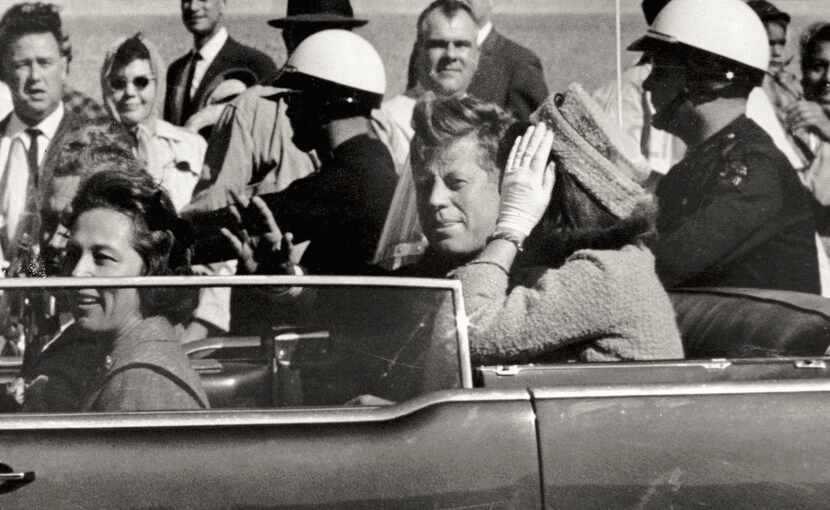 In this Nov. 22, 1963 file photo, President John F. Kennedy waves from his car in a...