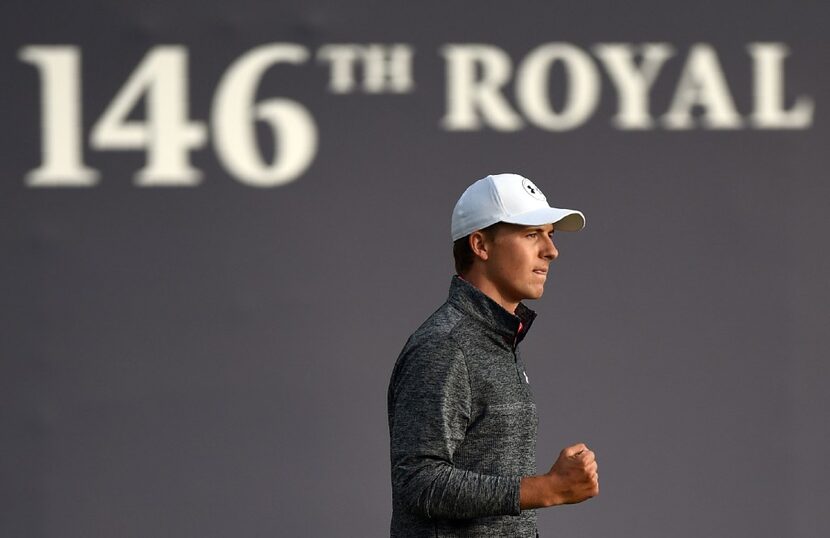 US golfer Jordan Spieth reacts to holing a putt on the 18th green after his third round on...